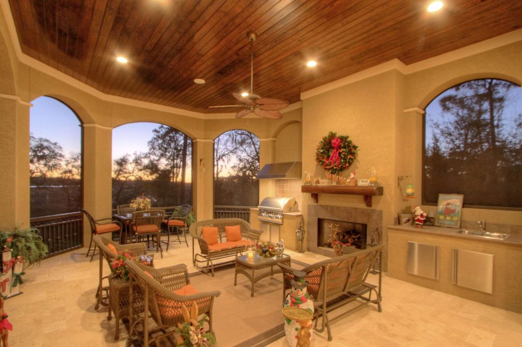 Example of a large tuscan backyard tile patio kitchen design in Atlanta with a roof extension