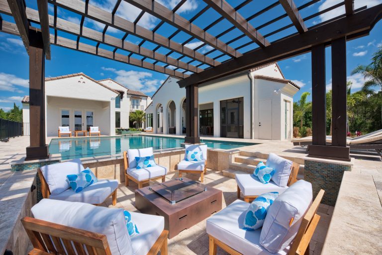 Example of a large tuscan backyard tile patio kitchen design in Orlando with a roof extension