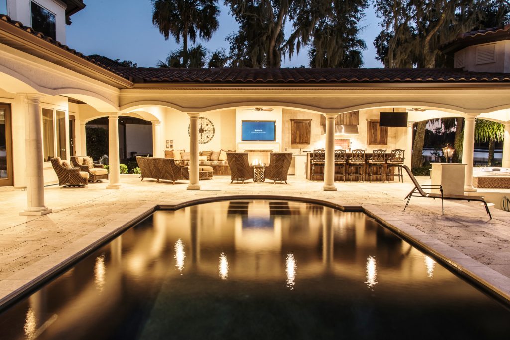 Example of a large tuscan patio kitchen design in Jacksonville with a roof extension