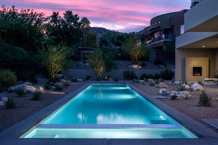 Example of a mid-century modern gravel and rectangular pool design in Las Vegas