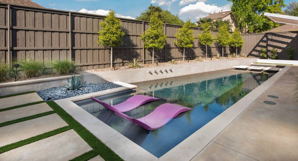 Example of a mid-sized 1950s backyard concrete and custom-shaped pool design in Dallas