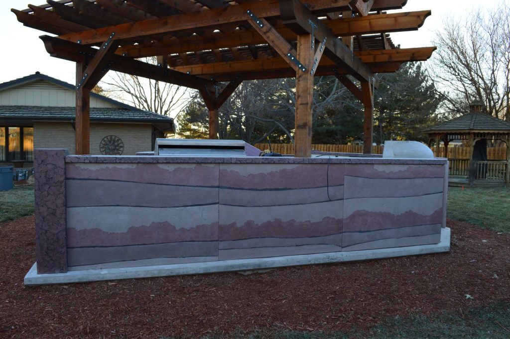 Example of a mid-sized arts and crafts backyard concrete patio kitchen design in Orange County with a pergola