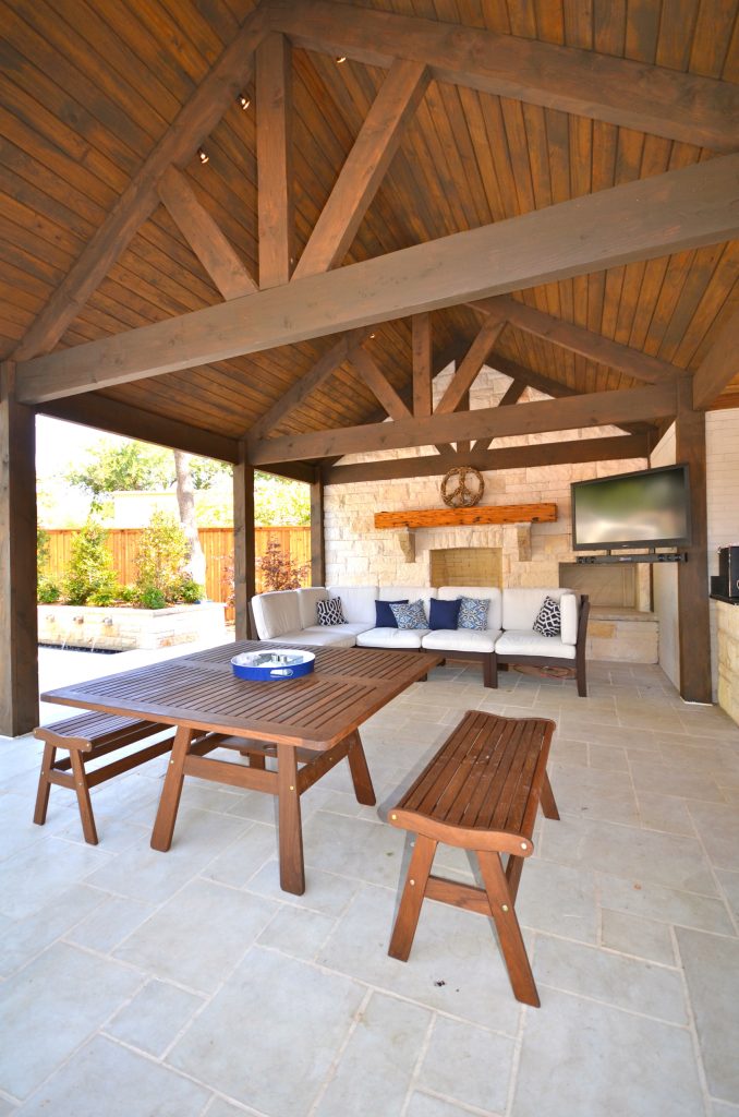 Example of a mid-sized arts and crafts backyard concrete paver patio kitchen design in Austin with a pergola