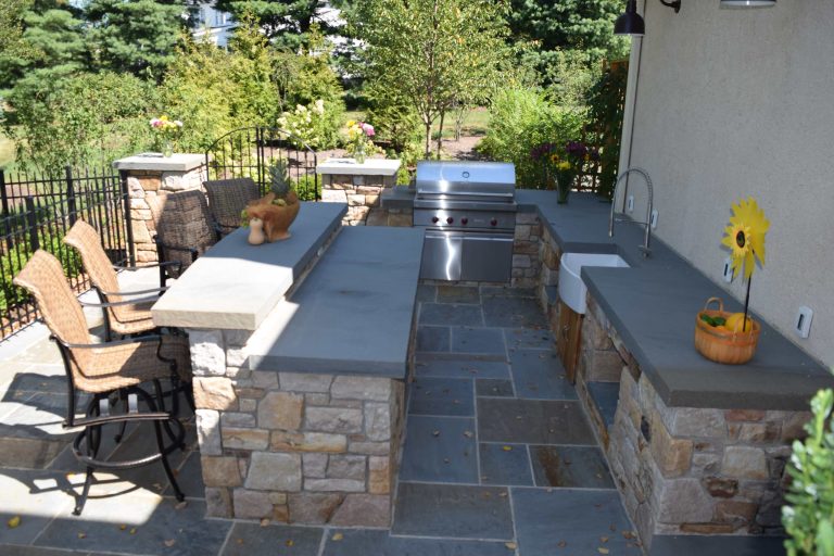 Example of a mid-sized arts and crafts backyard concrete paver patio kitchen design in Philadelphia with no cover