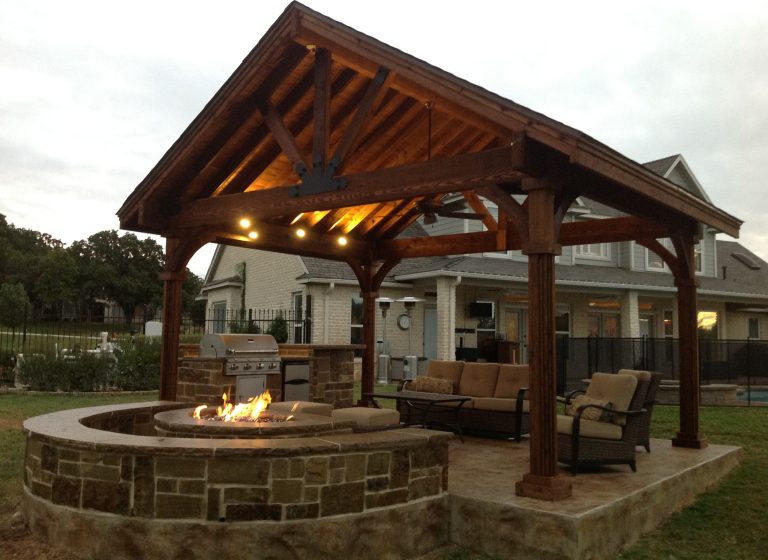 Example of a mid-sized arts and crafts backyard stamped concrete patio kitchen design in Dallas with a gazebo