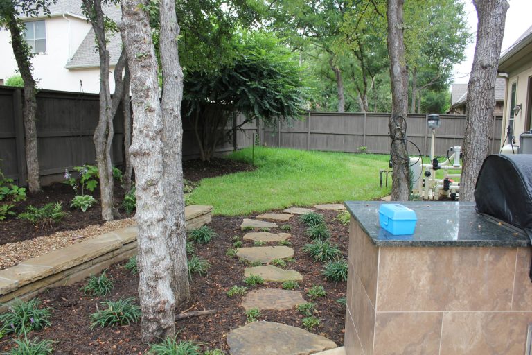 Example of a mid-sized backyard patio kitchen design in Dallas with a roof extension