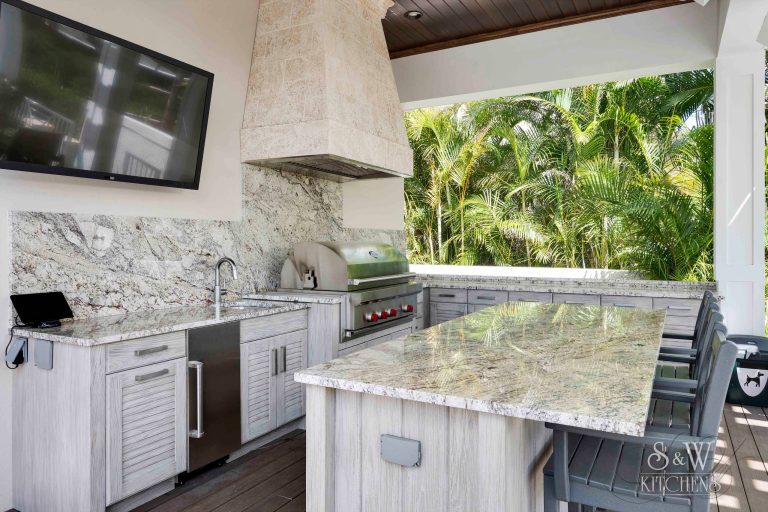 Example of a mid-sized beach style backyard patio kitchen design in Tampa with decking and a roof extension