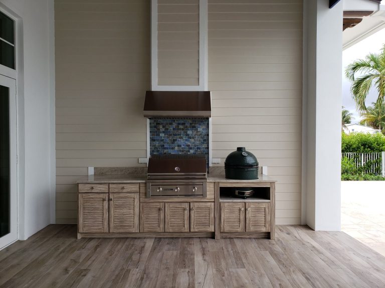 Example of a mid-sized beach style stone patio kitchen design in Other with a roof extension