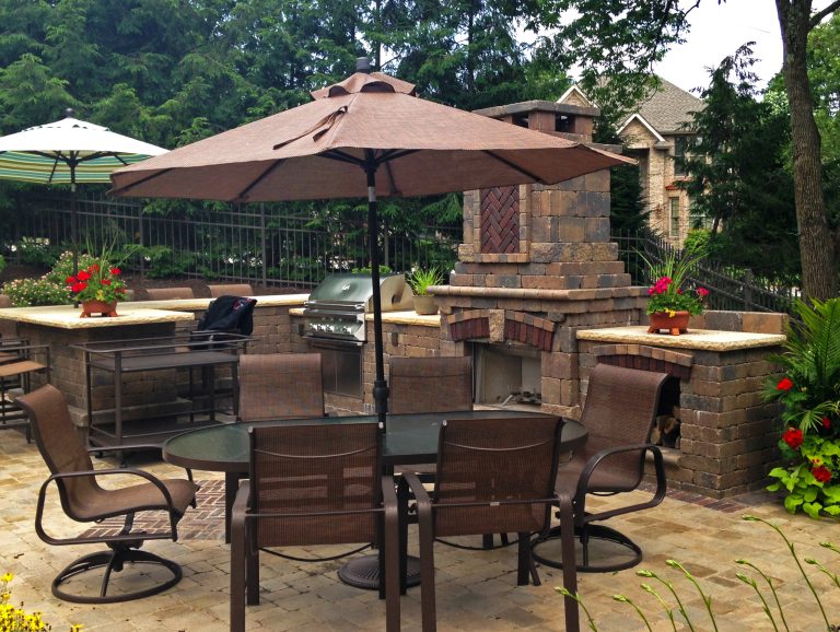Example of a mid-sized classic backyard brick patio kitchen design with no cover