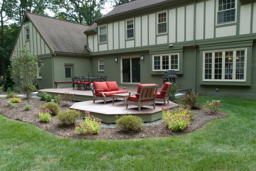 Example of a mid-sized classic backyard outdoor kitchen deck design in Manchester with no cover