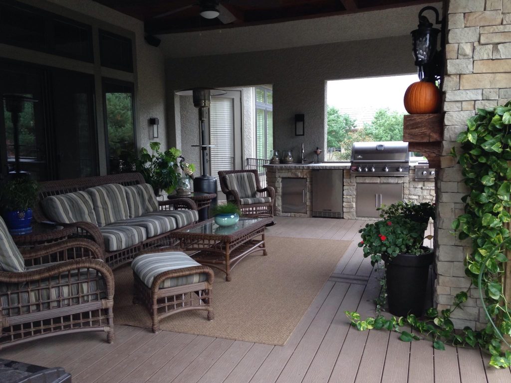 Example of a mid-sized classic backyard patio kitchen design in Kansas City with decking and a roof extension
