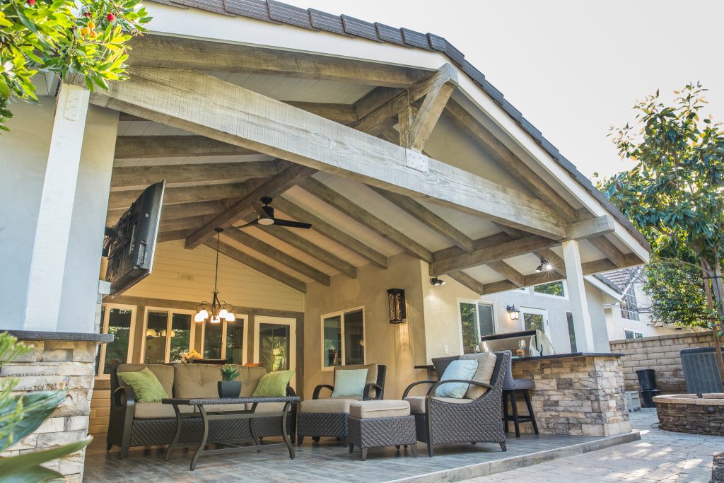 Example of a mid-sized classic backyard patio kitchen design in Los Angeles with decking and a roof extension