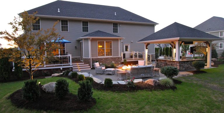Example of a mid-sized classic backyard stamped concrete patio kitchen design in Other with a roof extension