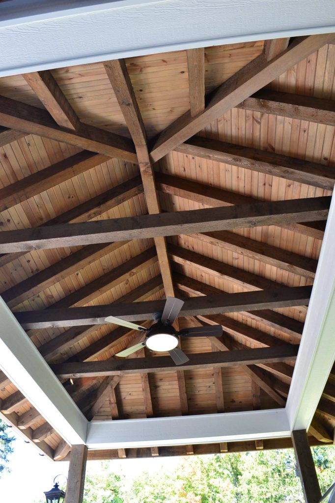 Example of a mid-sized classic backyard stone patio kitchen design in Cleveland with a gazebo