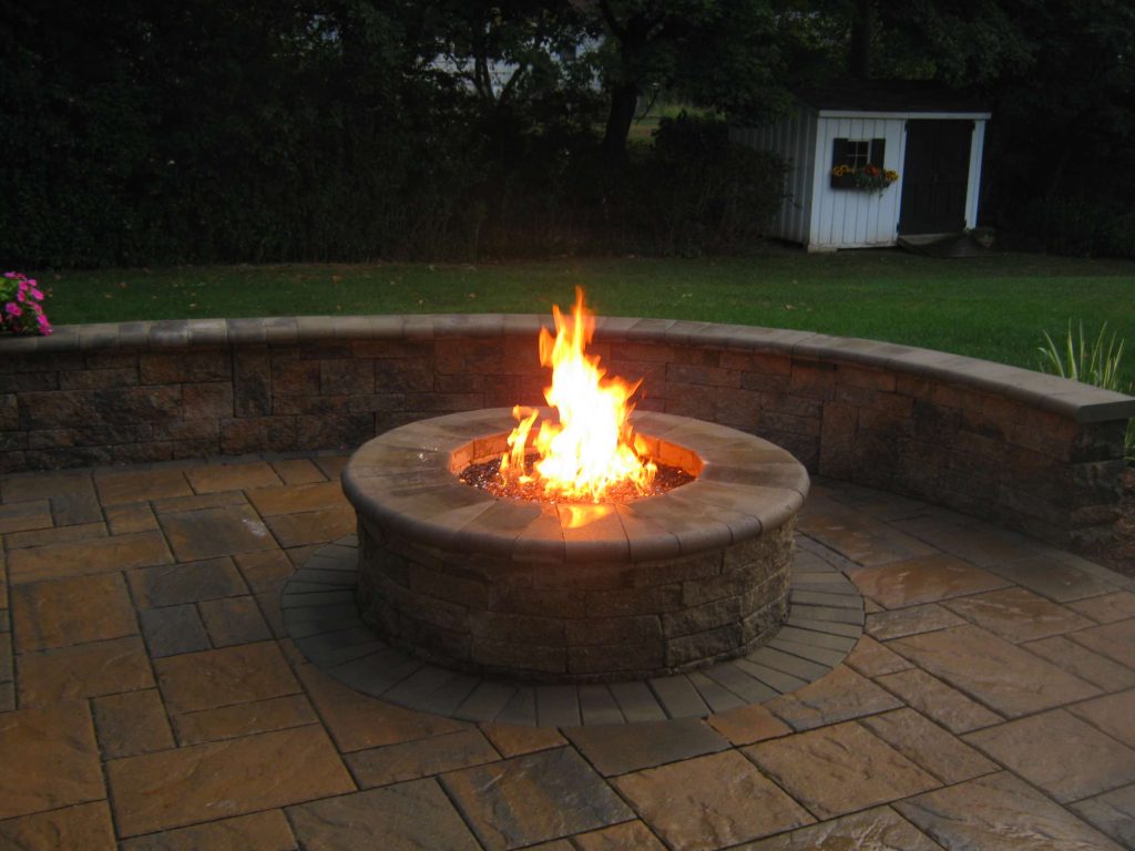 Example of a mid-sized classic backyard stone patio kitchen design in New York with no cover