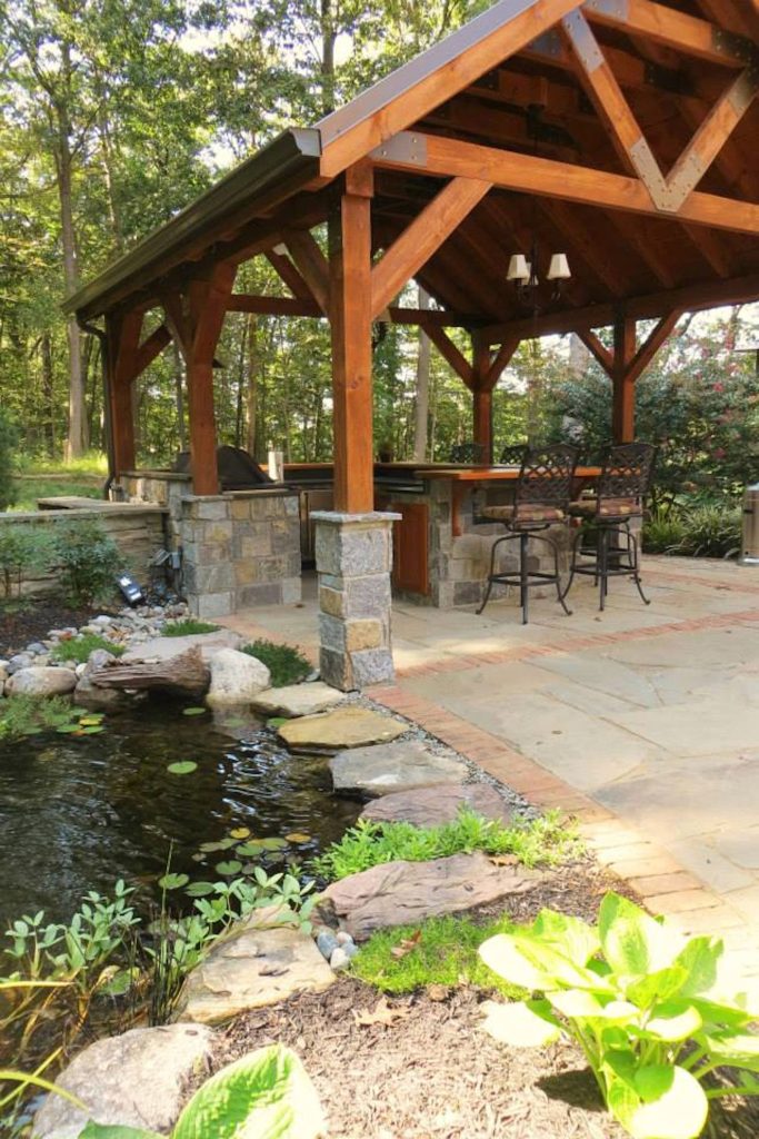 Example of a mid-sized classic backyard stone patio kitchen design in Philadelphia with a gazebo
