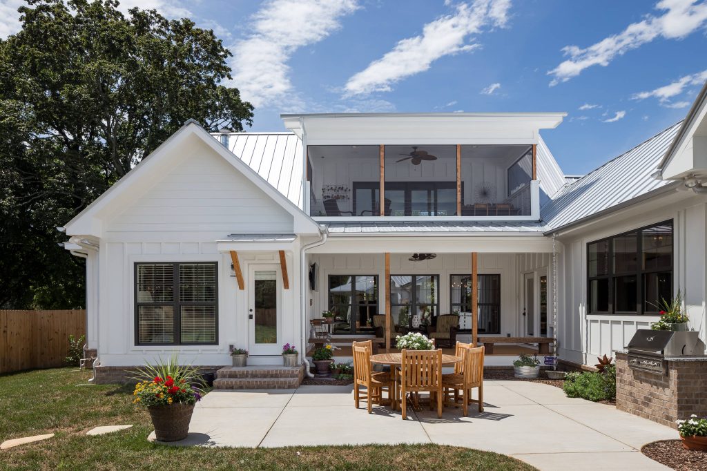 Example of a mid-sized cottage backyard concrete paver patio kitchen design in Nashville with a roof extension
