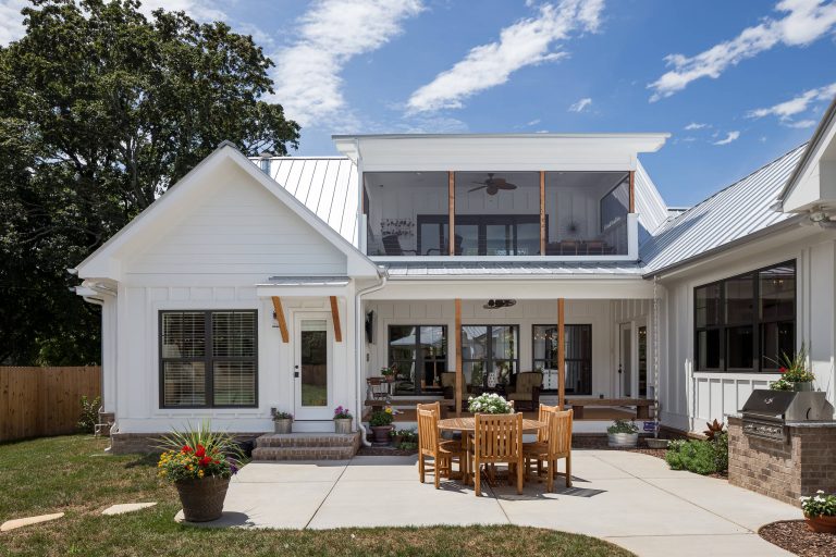 Example of a mid-sized cottage backyard concrete paver patio kitchen design in Nashville with a roof extension