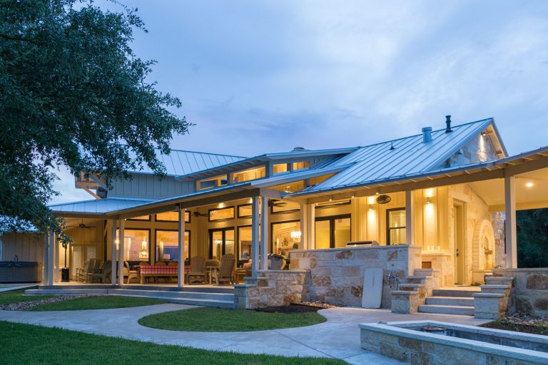 Example of a mid-sized country backyard concrete patio kitchen design in Houston with a roof extension