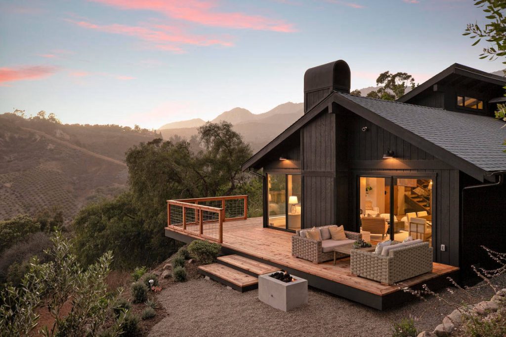 Example of a mid-sized country side yard deck design in Santa Barbara with a fire pit and no cover