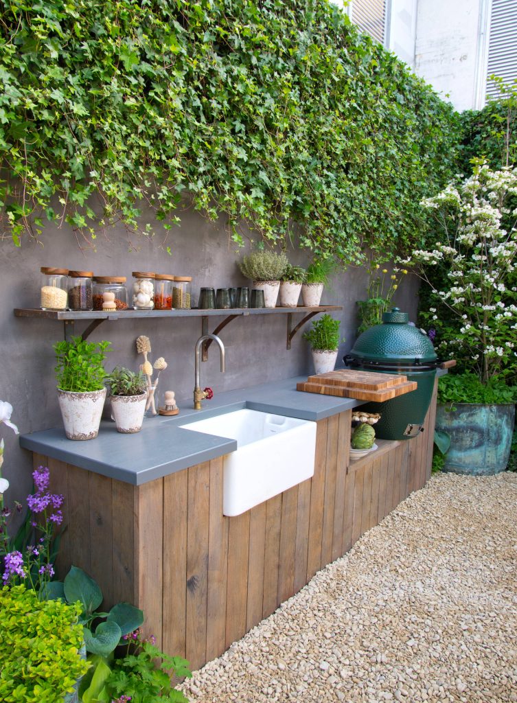 Example of a mid-sized farmhouse gravel patio kitchen design in Other with no cover