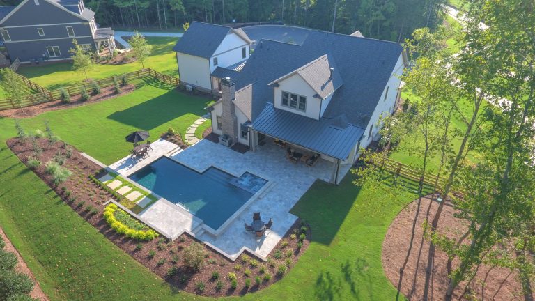Example of a mid-sized island style backyard outdoor kitchen deck design in Atlanta with a roof extension