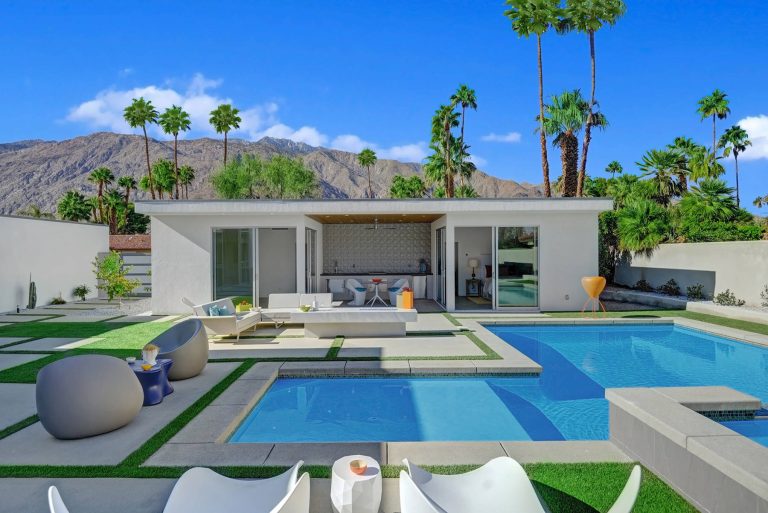 Example of a mid-sized minimalist backyard concrete paver and rectangular lap pool house design in Los Angeles