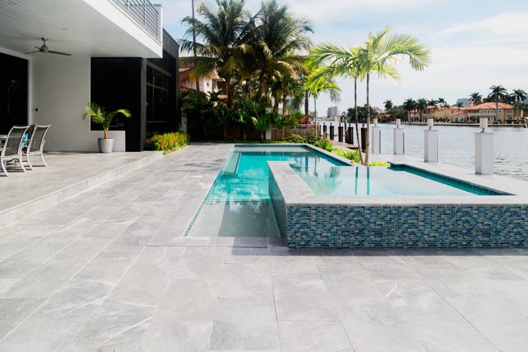 Example of a mid-sized minimalist backyard custom-shaped hot tub design in Miami