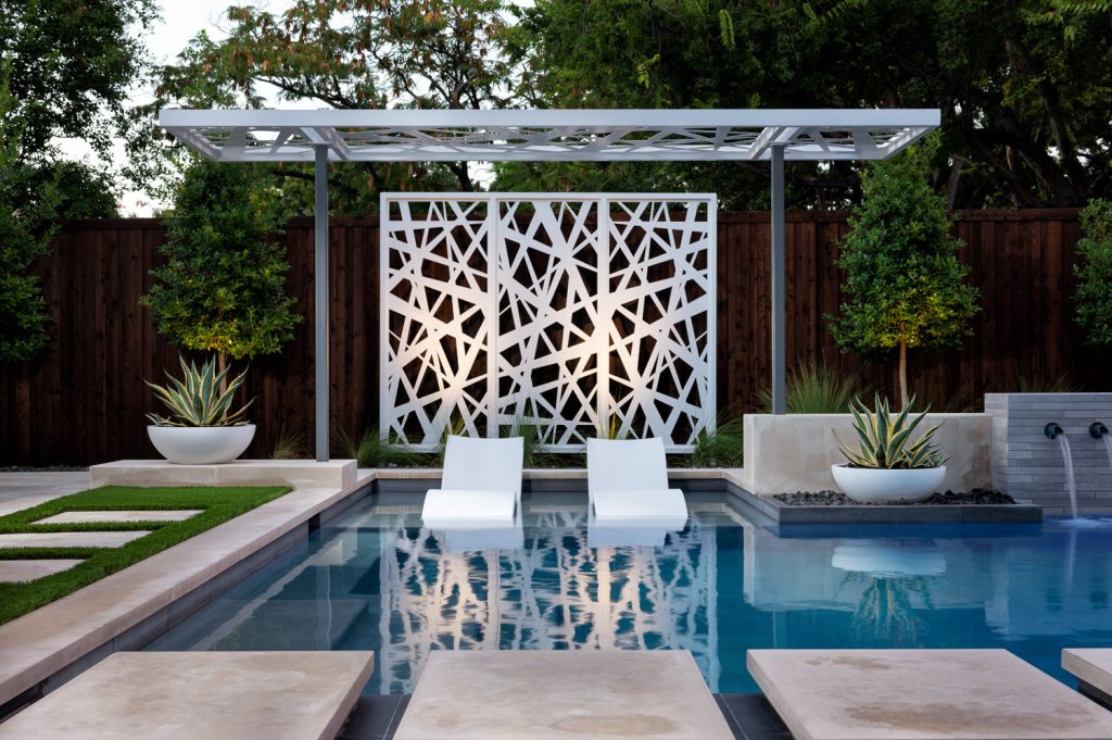 Example of a mid-sized minimalist backyard patio kitchen design in Dallas with decking and an awning