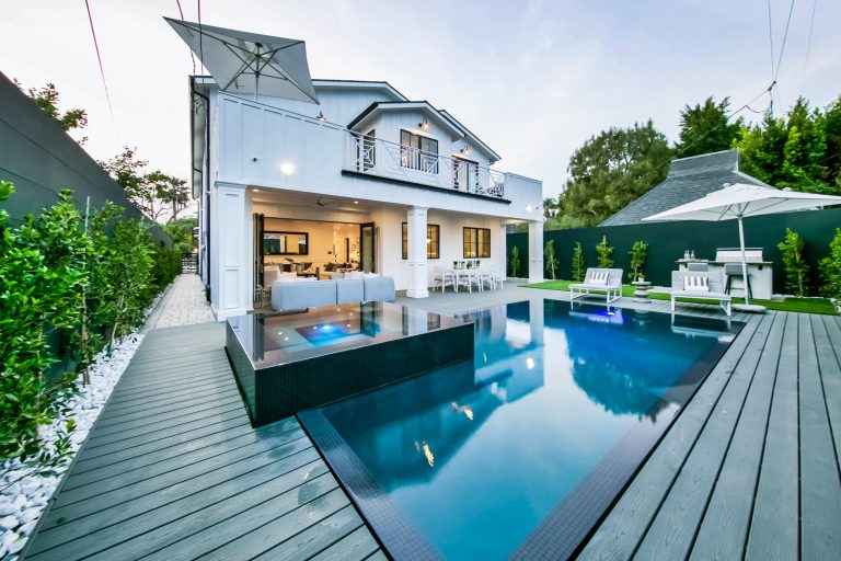 Example of a mid-sized minimalist backyard rectangular hot tub design in Los Angeles with decking