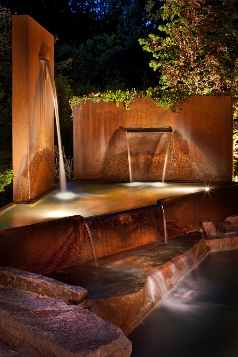Example of a mid-sized minimalist backyard stone and custom-shaped aboveground pool fountain design in Detroit