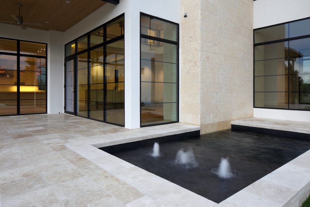 Example of a mid-sized minimalist backyard tile and rectangular lap pool fountain design in Dallas