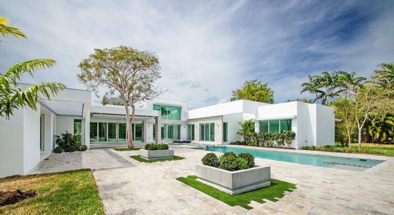 Example of a mid-sized minimalist backyard tile patio kitchen design in Miami with a pergola