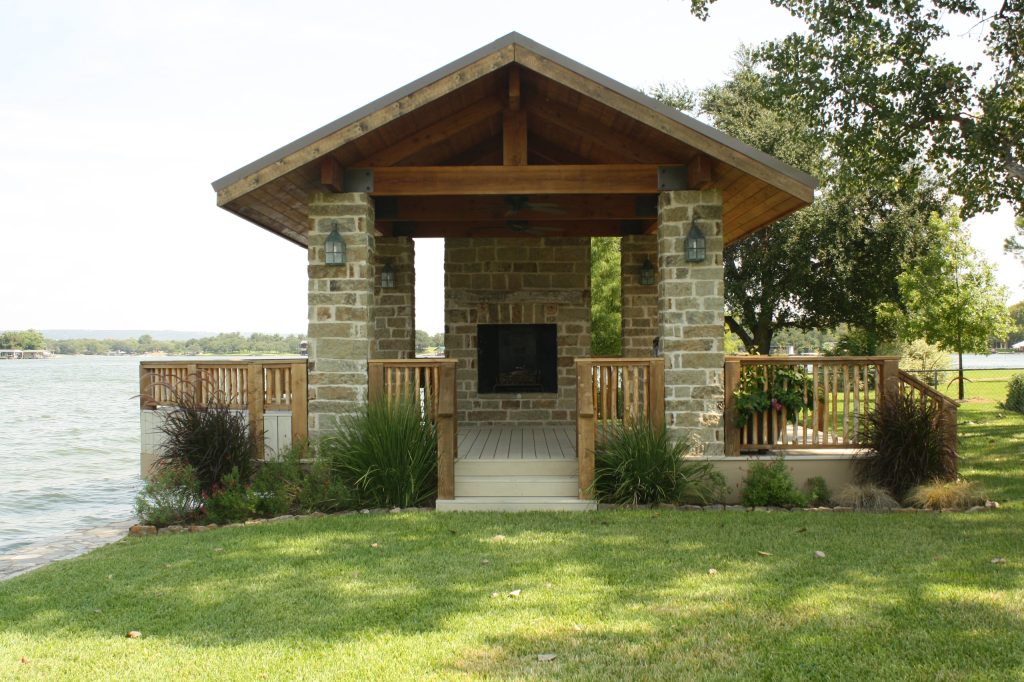 Example of a mid-sized mountain style backyard patio kitchen design in Austin with decking and a gazebo