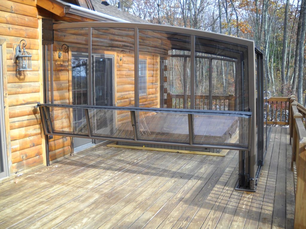 Example of a mid-sized mountain style backyard patio kitchen design in New York with an awning