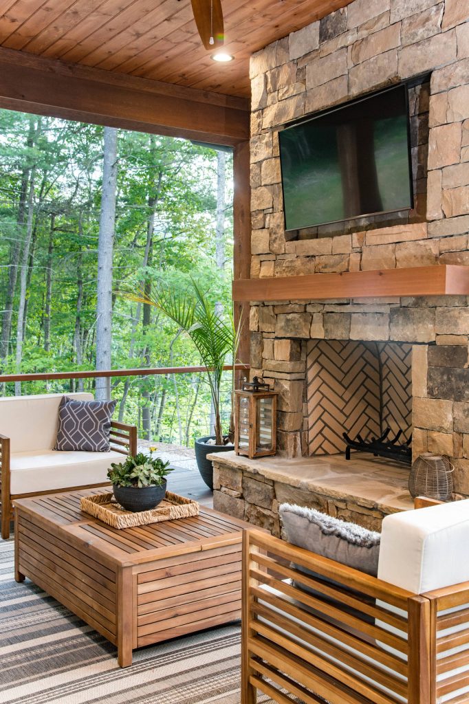 Example of a mid-sized mountain style backyard patio kitchen design in Other with decking and a roof extension