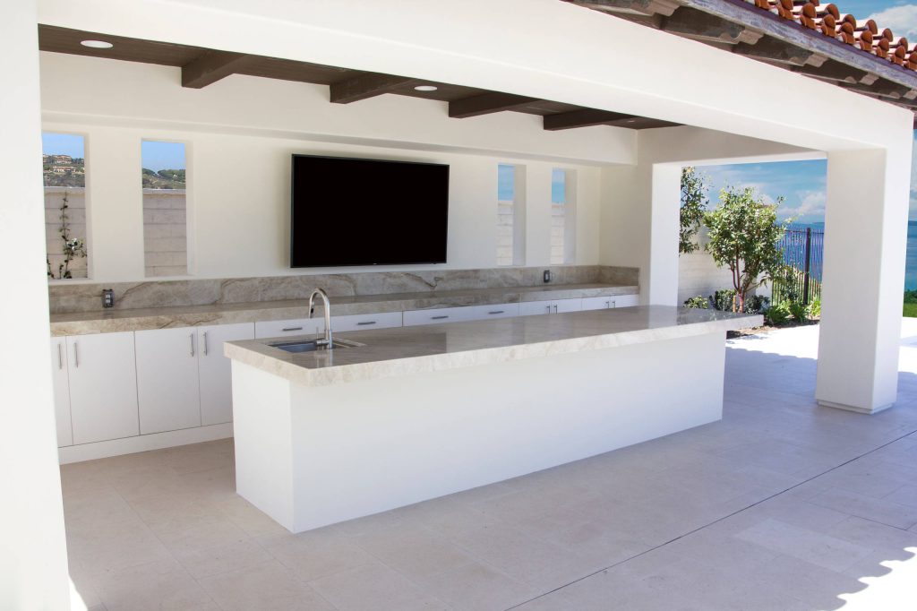 Example of a mid-sized southwest backyard concrete patio kitchen design in Orange County with a roof extension