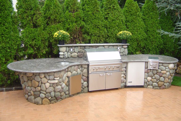 Example of a mid-sized transitional backyard brick patio kitchen design in New York with no cover