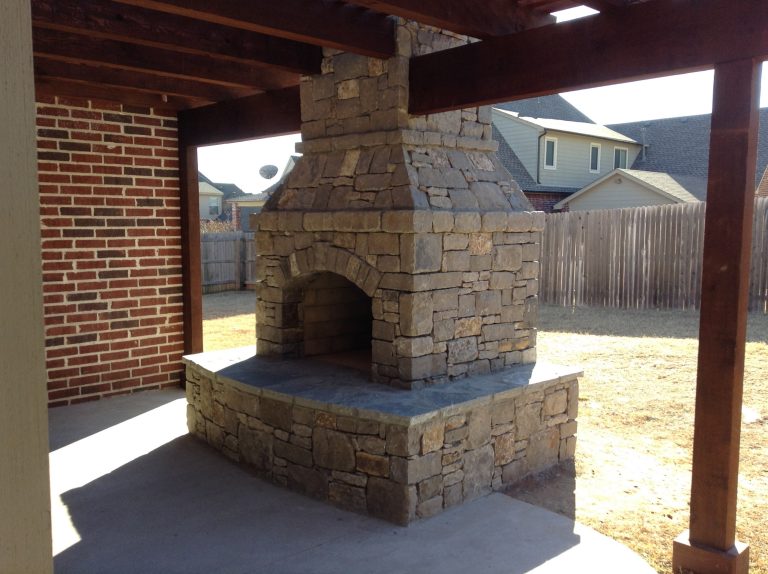 Example of a mid-sized transitional backyard concrete patio kitchen design in Other with a pergola
