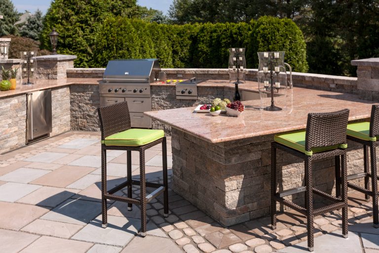 Example of a mid-sized transitional backyard concrete paver patio kitchen design in New York with no cover