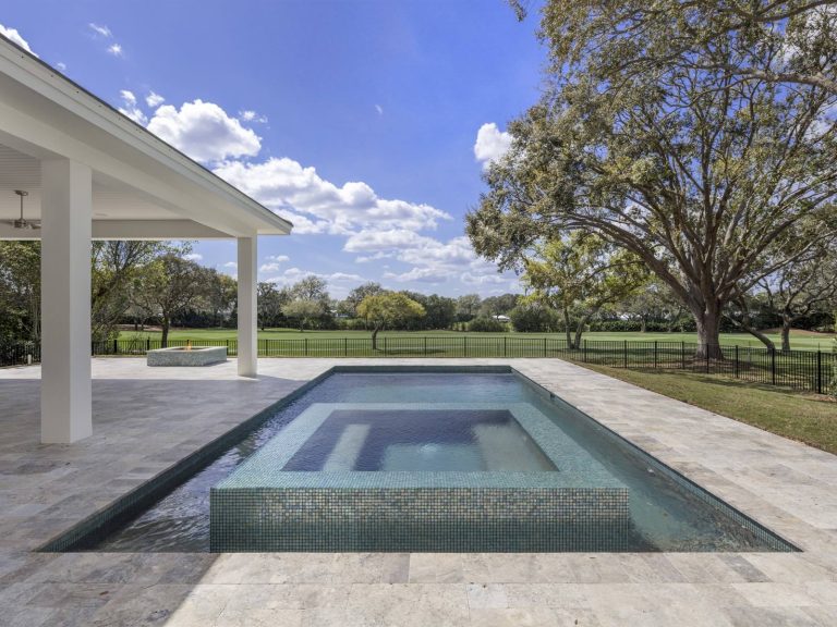Example of a mid-sized transitional backyard stone and rectangular hot tub design in Orlando