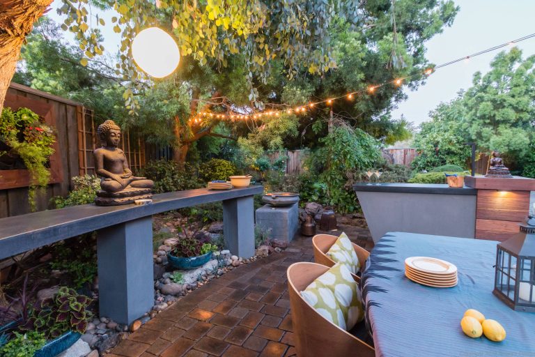 Example of a mid-sized transitional backyard stone patio kitchen design in San Francisco with no cover