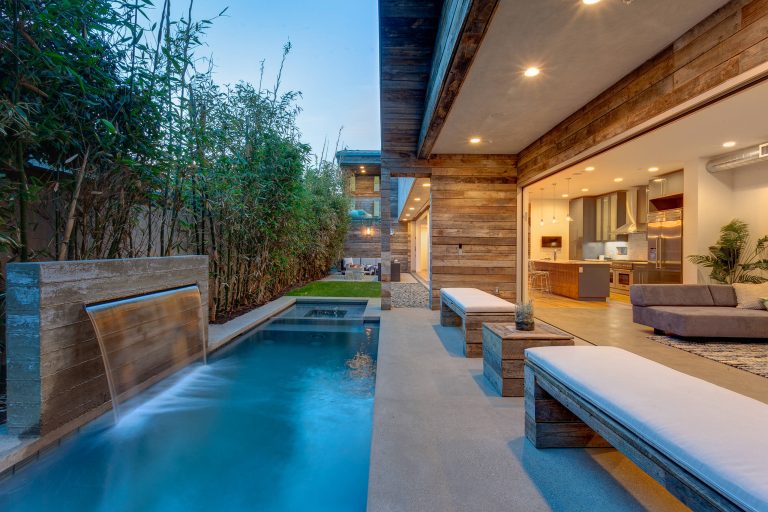 Example of a mid-sized trendy backyard concrete and rectangular lap pool fountain design in Los Angeles