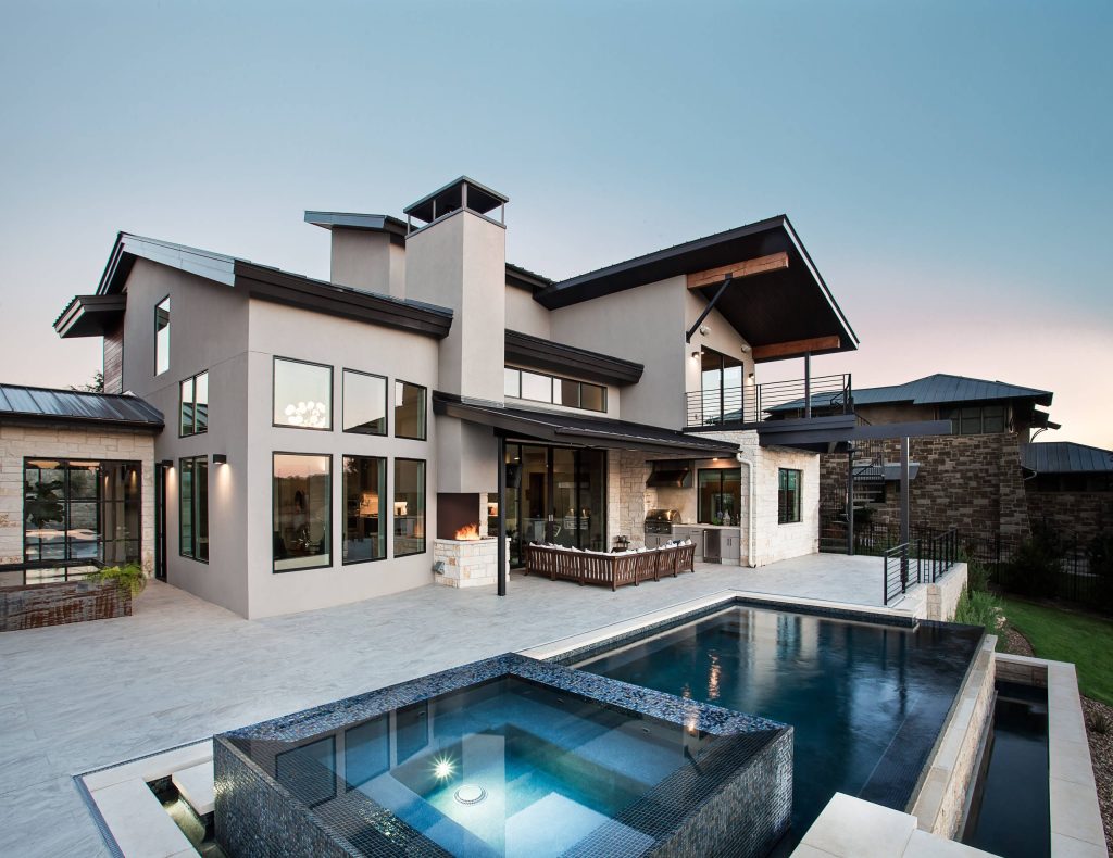 Example of a mid-sized trendy backyard concrete patio kitchen design in Austin with a roof extension