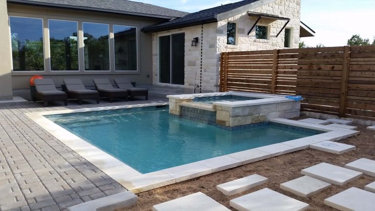 Example of a mid-sized trendy backyard concrete paver and rectangular hot tub design in Austin