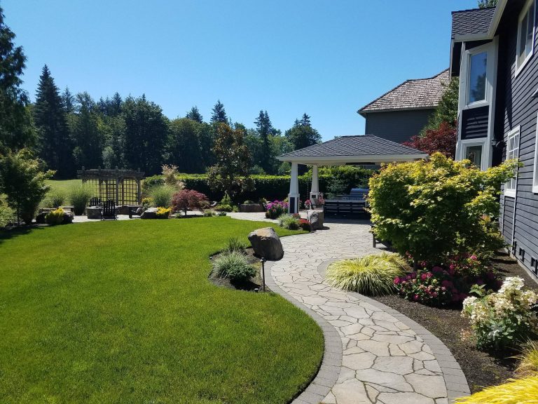 Example of a mid-sized trendy backyard concrete paver patio kitchen design in Seattle with a gazebo