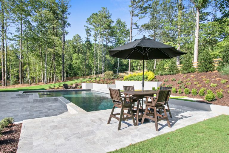 Example of a mid-sized trendy backyard stone and custom-shaped pool fountain design in Atlanta