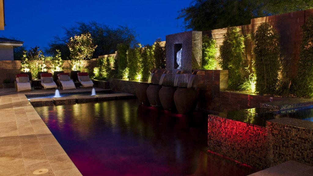 Example of a mid-sized trendy backyard stone and rectangular pool design in Las Vegas