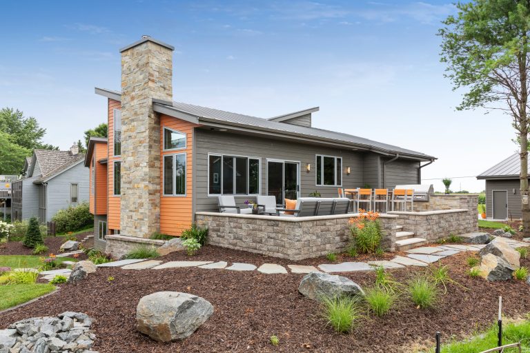 Example of a mid-sized trendy backyard stone patio kitchen design in Other with no cover
