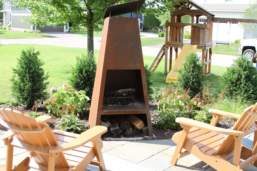 Example of a mid-sized trendy front yard stone patio kitchen design in Minneapolis with no cover